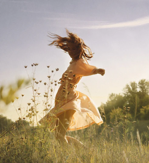 photo - girl dancing in field